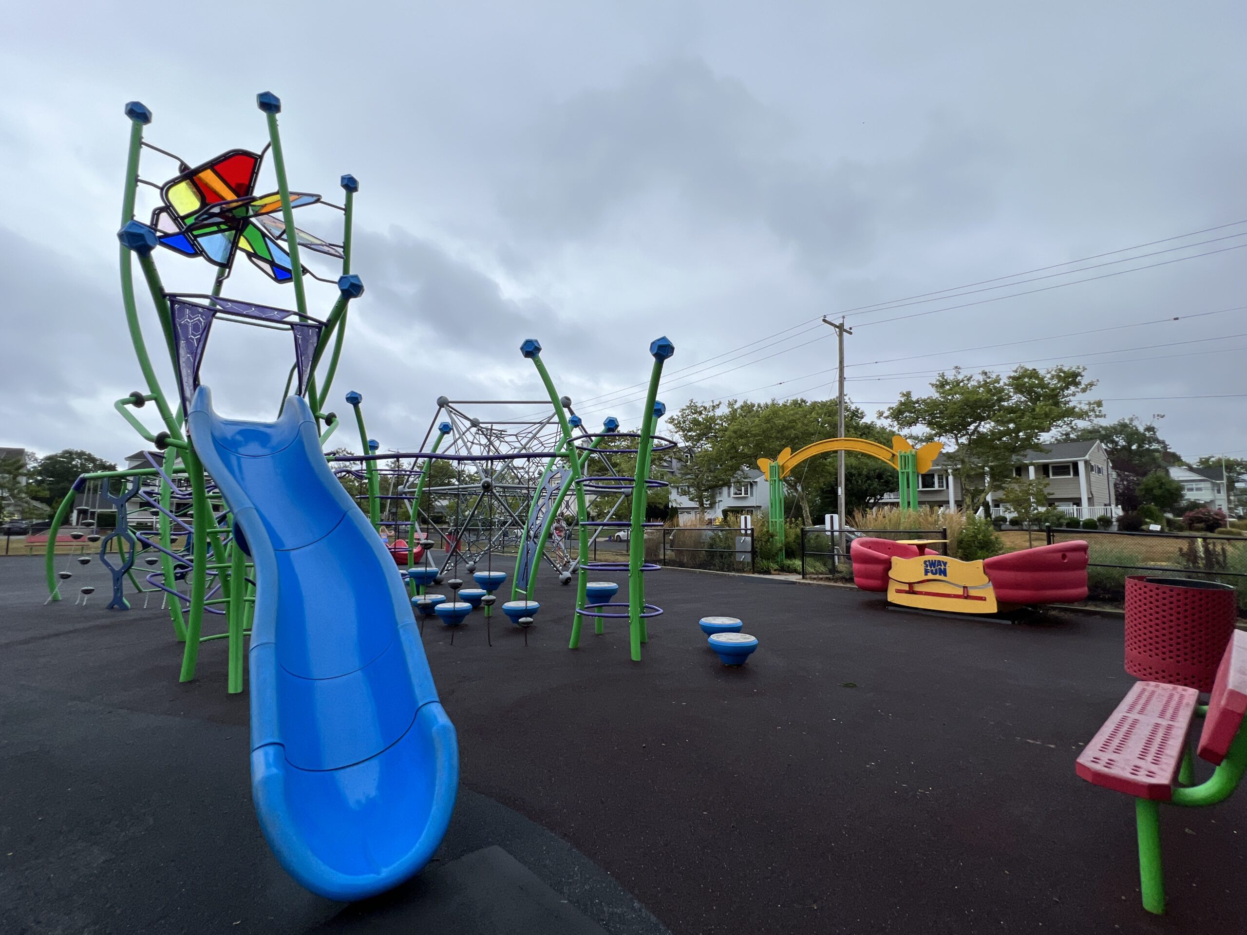 WIDE image - Blue slide, green climbing structure, and sway fun at Jane Magovern's Playground in Belmar NJ