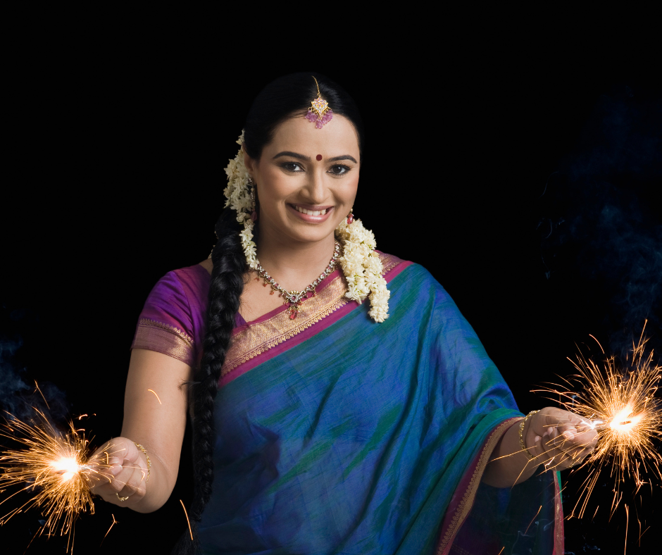 Woman celebrating diwali festival with sparklers