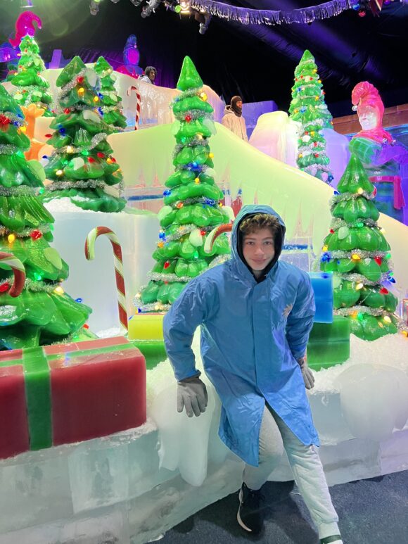 ICE at Gaylord's National Resort - boy in blue parka with christmas tree ice sculptures - MAIN image