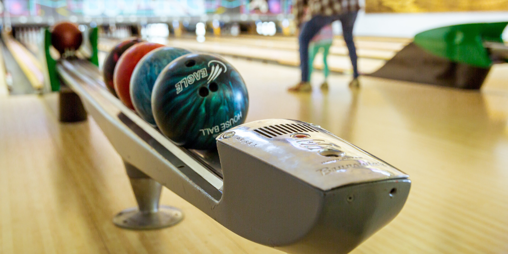 Bowling balls line up in rack at bowling alley near me in nj