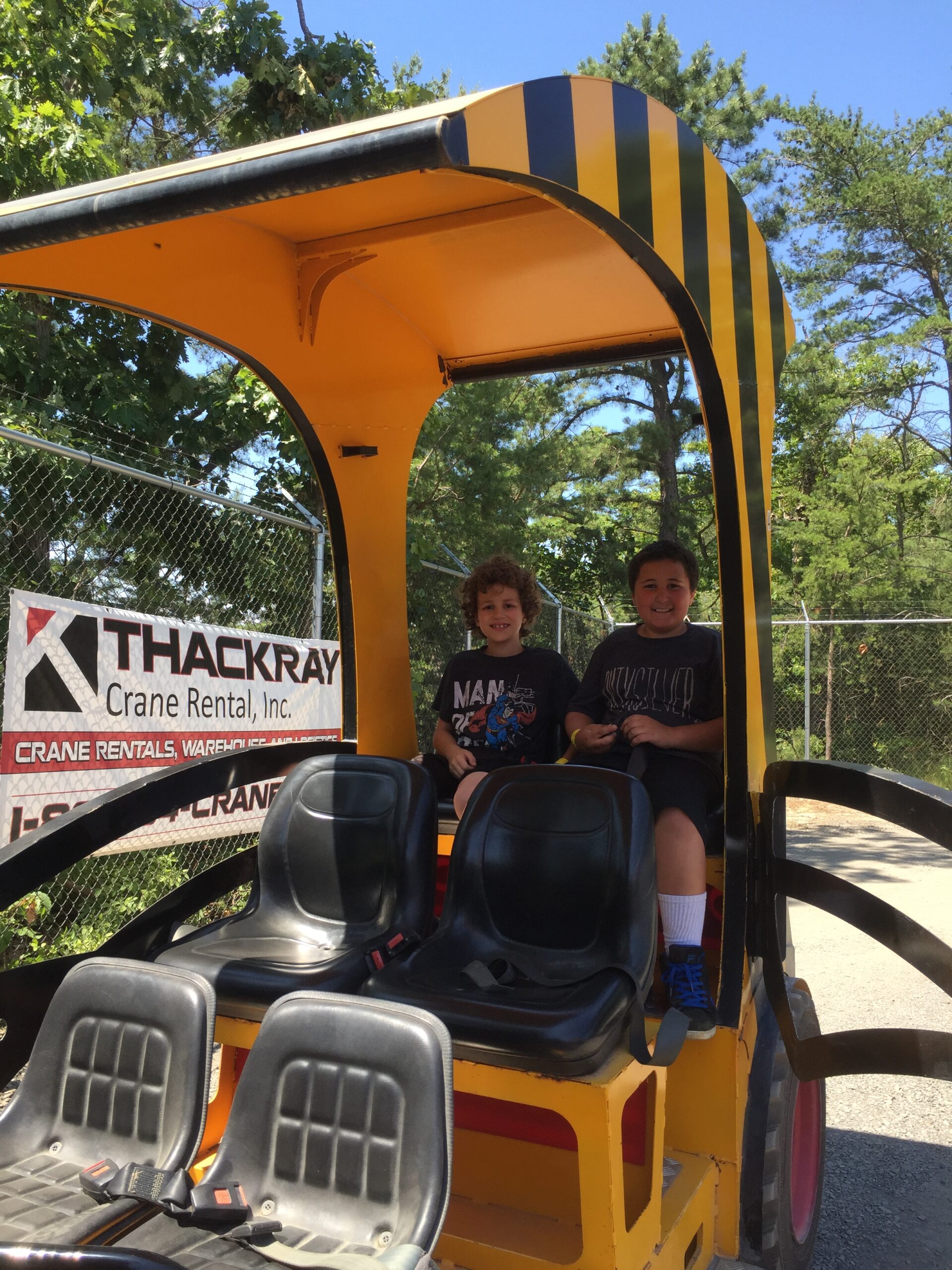 2 boys ride inside the Excavator Express