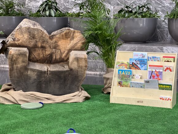 a heart-shaped wooden seat sits next to storybooks at the Philadelphia Flower Show's Kids Cocoon, an area with activities for kids