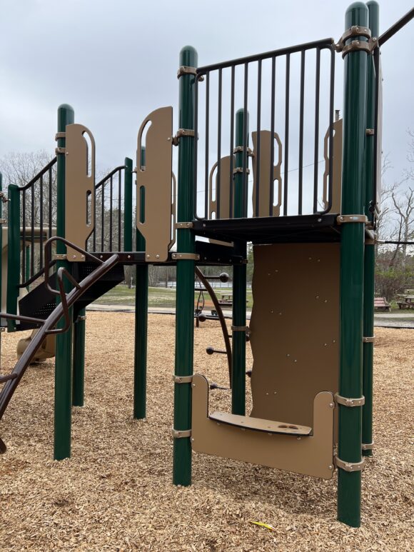 Shady area under larger structure at Birch Grove Park Playground in Northfield NJ PORTRAIT image