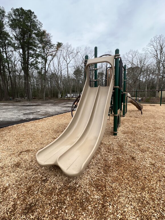 Tall Side by side slides on larger structure at Birch Grove Park Playground in Northfield NJ PORTRAIT image